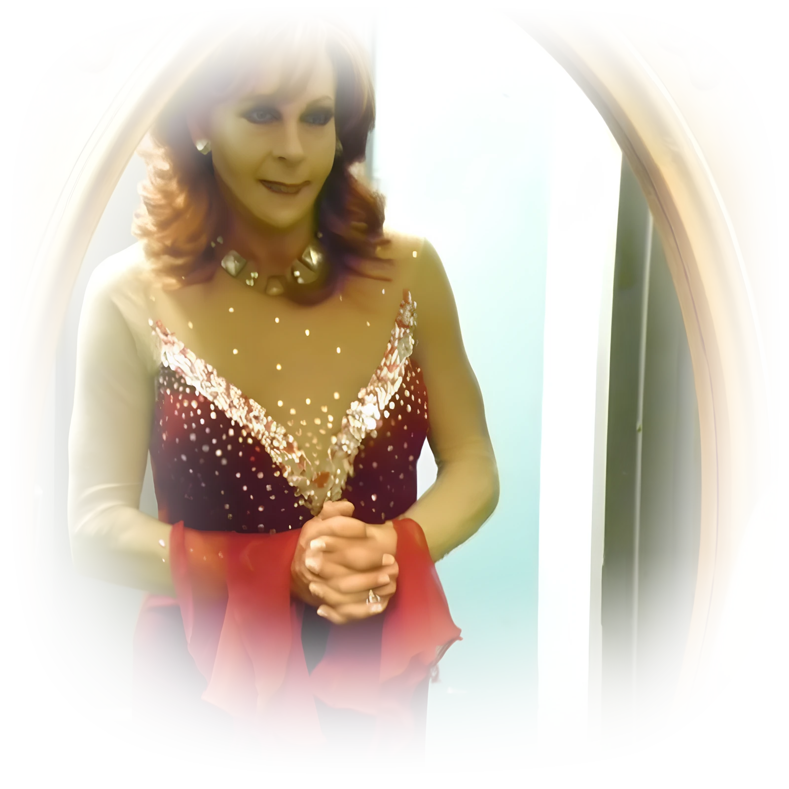 Coti Collins, Miss Gay America 2011, in a red beaded gown, looking at her reflection in a gilded dressing room mirror.